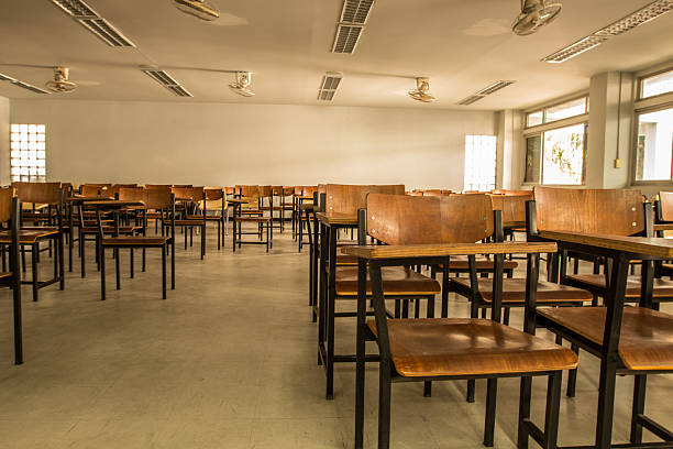 istock Old scattered chairs in the classroom. 629048998