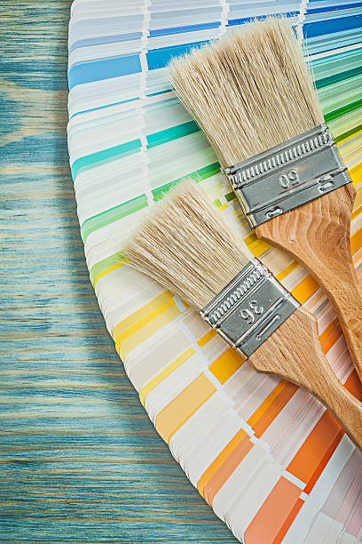 istock Color palette paint brushes on wooden board construction concept 629049524
