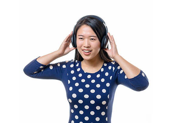 smiling young chinese woman with earphones - xian audio imagens e fotografias de stock