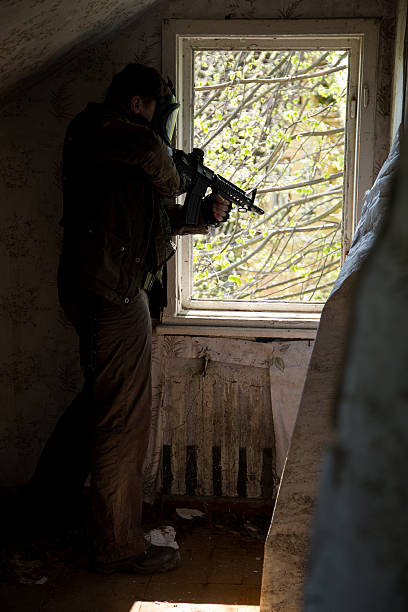 istock man with a gun in the Abandoned destroyed house 629053074