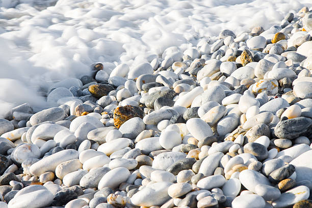 istock Rounded and smooth pebbles wet by seawater 629053646