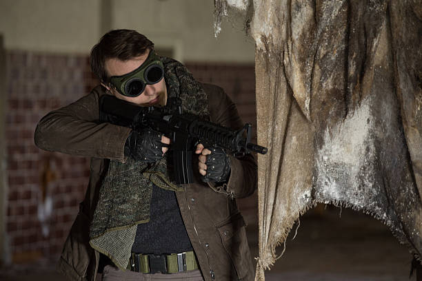istock man with a gun in the Abandoned destroyed house 629053886