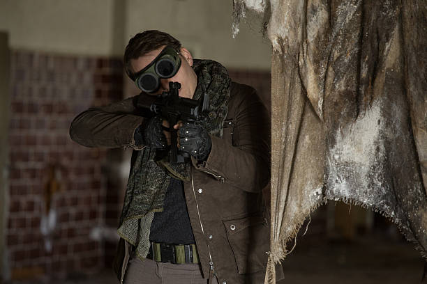 istock man with a gun in the Abandoned destroyed house 629053950