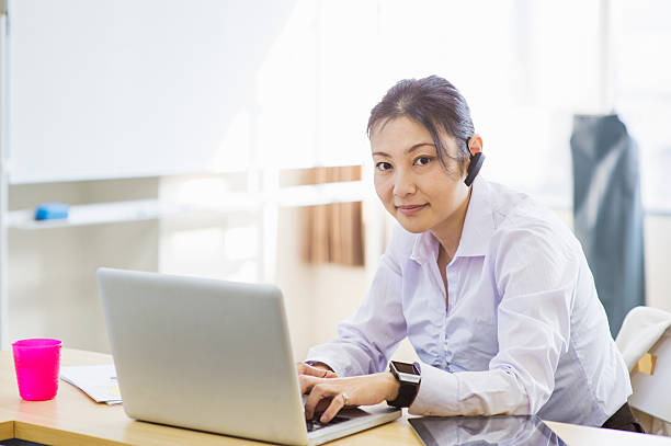 istock Business woman using smart phone and smart watch 629054362