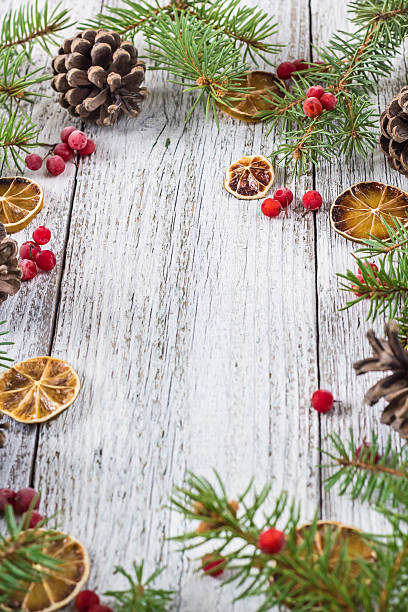 istock Christmas branches with cones viburnum berries and dry lemon slice 629061394