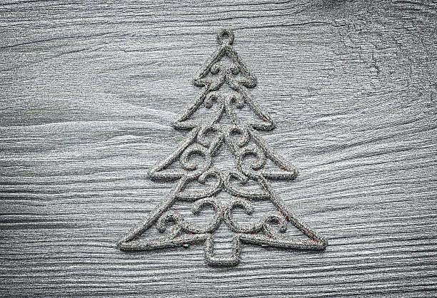 istock Wooden silver Christmas tree decoration on wood board celebratio 629064232