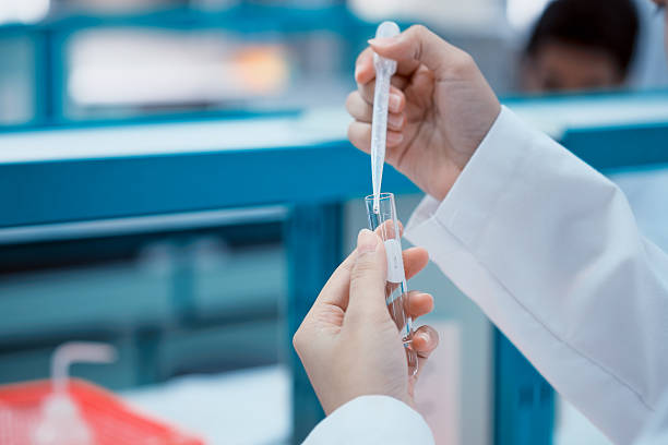 Hand of scientist and pipette