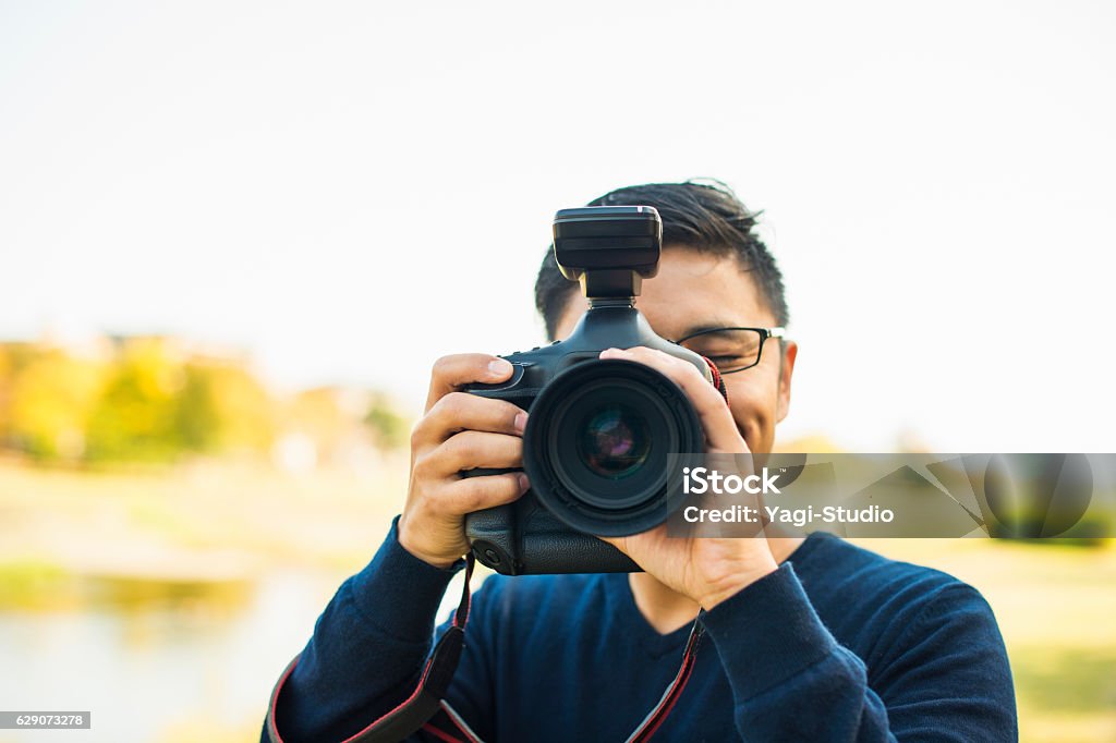 Professional Photographer taking a photo Portrait of Japanese mature adult man Photographer Stock Photo