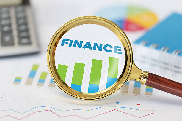 istock Magnifying glass and calculator on finance graph 629073512