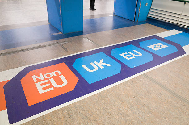 EU and UK Passport Control Signage at London Gatwick Airport Crawley, England - December 2, 2016: Passport control signage on the floor at Gatwick Airport directs passengers to 'non EU', 'UK' and 'EU' passport control points. The UK government is yet to pronounce on post-brexit immigration policy. gatwick airport photos stock pictures, royalty-free photos & images