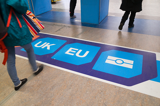 Crawley, England - December 2, 2016: Passport control signage on the floor at Gatwick Airport directs passengers to 'non EU', 'UK' and 'EU' passport control points. The UK government is yet to pronounce on post-brexit immigration policy.