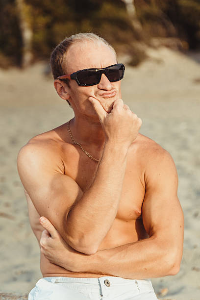 istock slender man in shorts on a beach 629075758