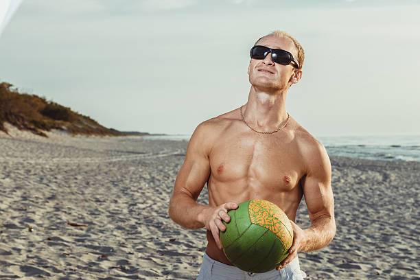 slender man in shorts on a beach - men refreshment male summer imagens e fotografias de stock