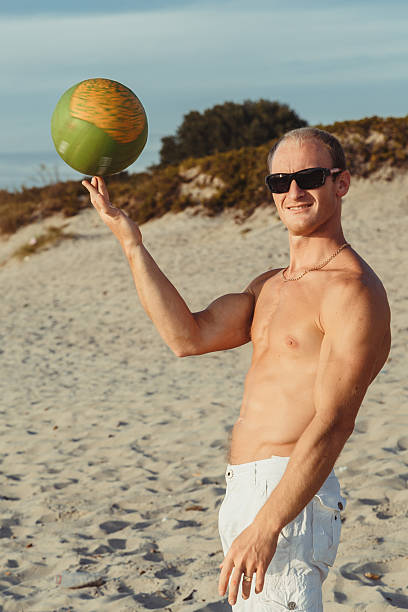 slender man in shorts on a beach - men refreshment male summer imagens e fotografias de stock