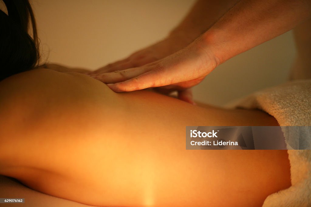 Woman enjoying a massage treatment. Woman during a massage treatment in spa. Massaging Stock Photo