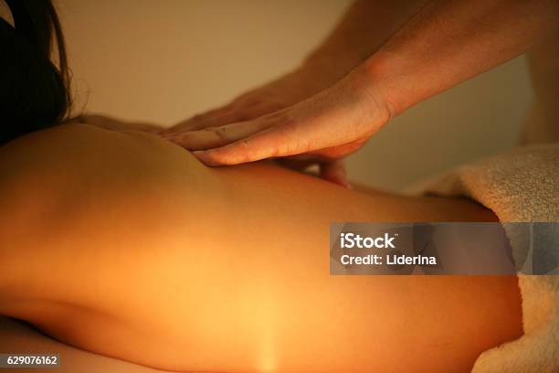 Woman Enjoying A Massage Treatment Stock Photo - Download Image Now - Massaging, Thai Culture, Thai Ethnicity