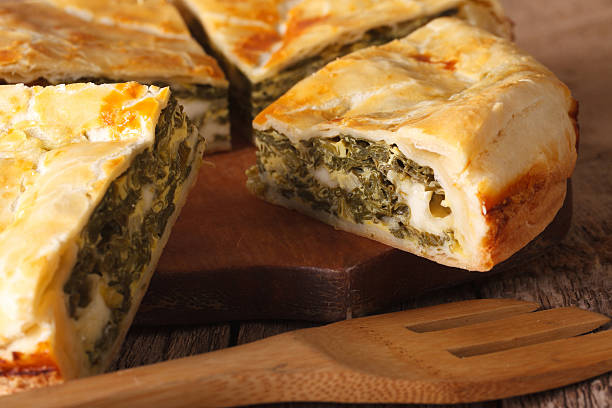 istock Freshly baked Greek pie with spinach macro. horizontal 629076752