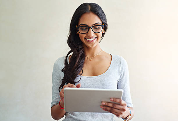 She’s got everything she could need online Studio shot of an attractive young woman using a digital tablet beauty fashion model adult beautiful stock pictures, royalty-free photos & images