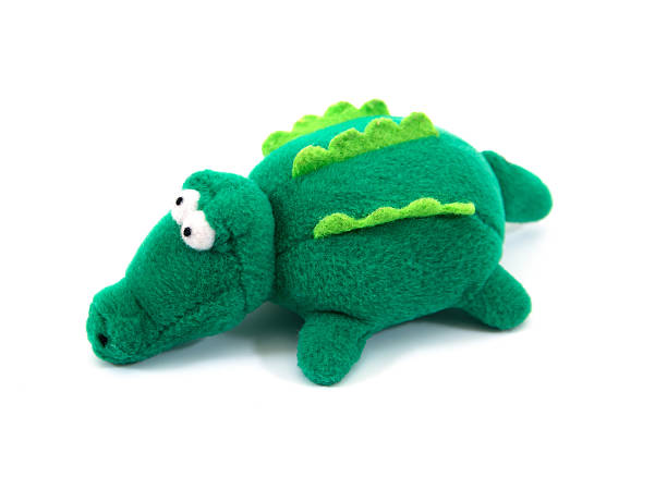 istock Green crocodile fabric doll isolated on white background. 629077730