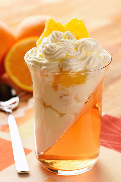 istock Orange jelly with whipped cream and orange fruit. 629078010