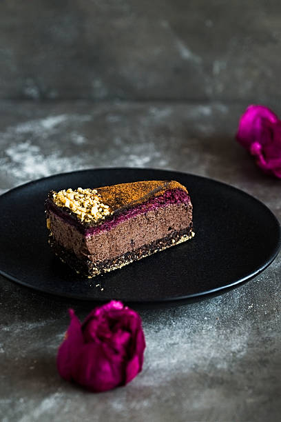 istock Dark chocolate cake cut with rose on  black plate 629079562