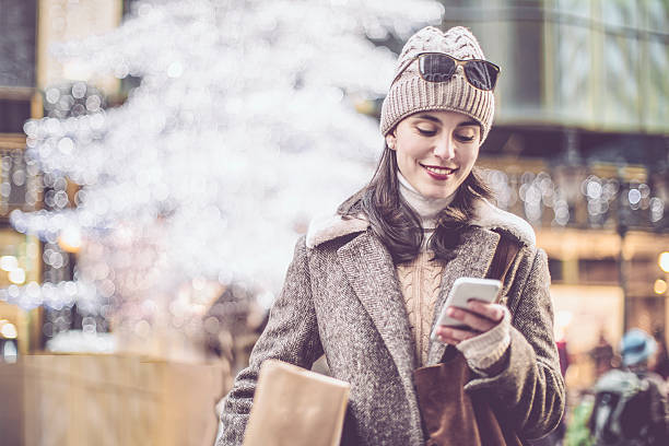 Winter shopping season Young woman shopping in the city at Christmas time christmas market photos stock pictures, royalty-free photos & images