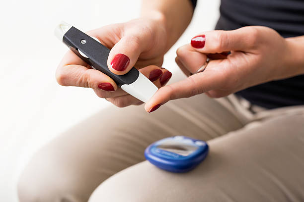 persona che usa il kit diabete sul dito - blood sugar test examining instrument of measurement diabetes foto e immagini stock
