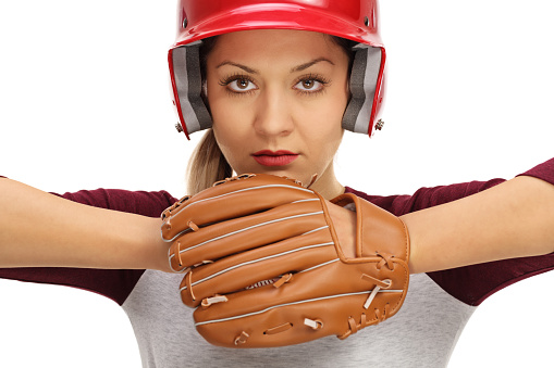 Female baseball player ready to pitch isolated on white background