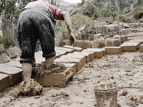  Paru Paru, Pisaq, Peru - October 22, 2012: Making traditional adobe mud bricks in Paru Paru Community Village, Pisaq district, Cusco region, Peru