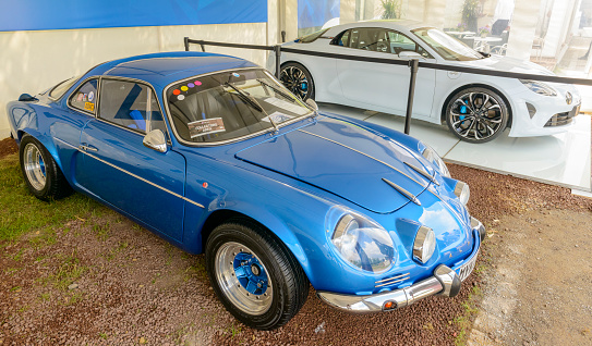 Jüchen, Germany - August 5, 2016: Alpine A110 1970s French sports car with the Alpine Vision Renault 2017 sports car in the background. The Alpine VIsion is a modern interpretation of the Alpine 110 1970s sports car and succesful rally car. The Alpine Vision will be introduced in 2017.