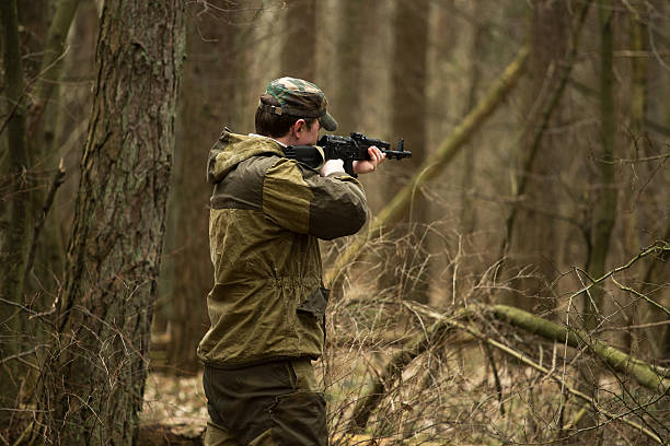 istock military man in the woods with a Kalashnikov assault rifle 629127976