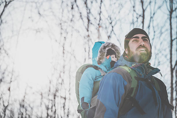Father Backpacking Hiking with Baby in Winter Forest