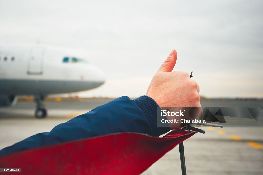 OK sign Member of ground crew is showing OK sign to pilot before take off. Airplane Stock Photo