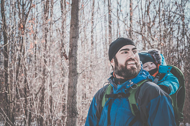 istock Father Backpacking Hiking with Baby in Winter Forest 629128310