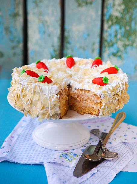 istock Carrot cake with icing and little carrots 629128372
