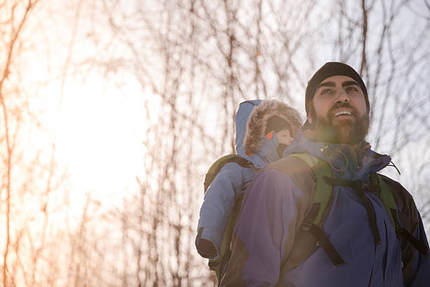 istock Father Backpacking Hiking with Baby in Winter Forest 629129608