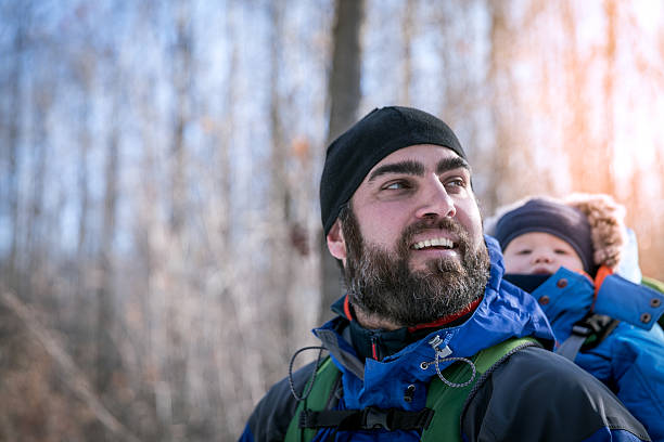 istock Father Backpacking Hiking with Baby in Winter Forest 629129644