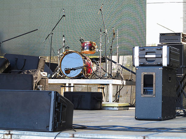istock Drum set, microphones and speakers on stage 629129896