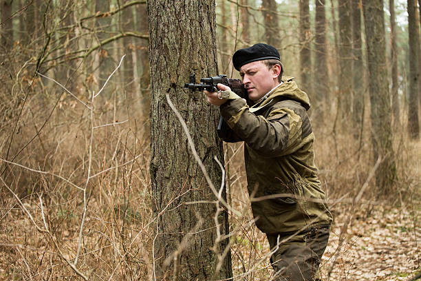 istock military man in the woods with a Kalashnikov assault rifle 629130168