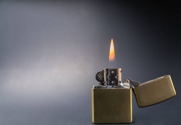 istock Vintage gold style lighter with flame close up 629142814