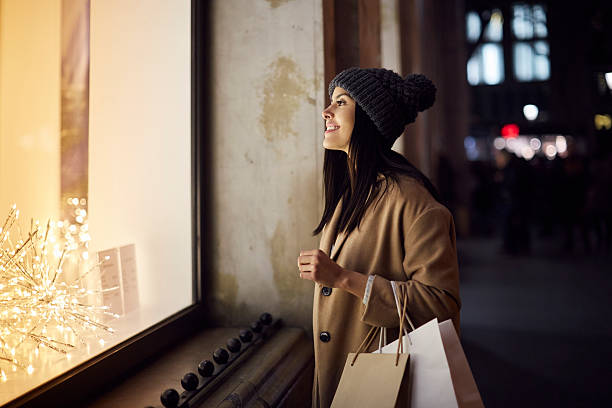 Christmas shopping looking at a window shop.