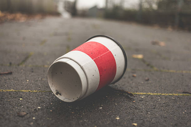 istock Used Coffee mug at sidwalk as symbol for pollution. 629143186