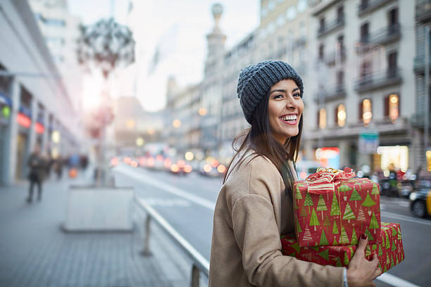 Hialing a taxi after some christmas shopping. Christmas shopping. Shot in Barcelona with Latin American and Polish models shopping bag photos stock pictures, royalty-free photos & images
