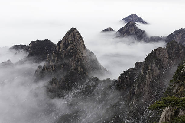 Huangshan (Yellow Mountains) China. Huangshan (Yellow Mountains), a mountain range in southern Anhui province in eastern China. It is a UNESCO World Heritage Site, and one of China's major tourist destinations. huangshan mountains stock pictures, royalty-free photos & images
