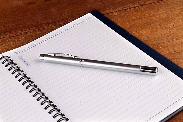 istock notebook with pen on old wooden table 629144490