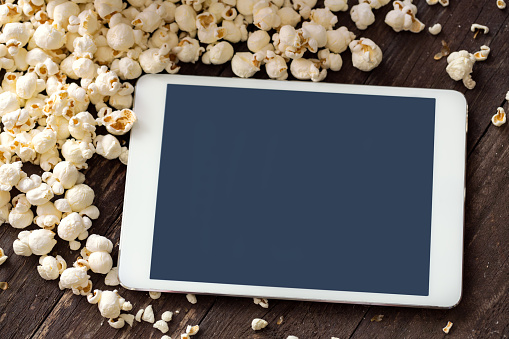 fresh popcorn with digital touch screen tablet