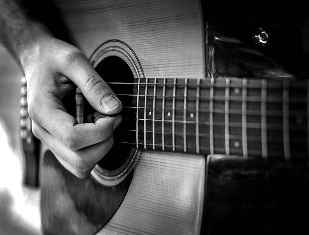 istock Black and White guitar player playing song outdoor 629145802