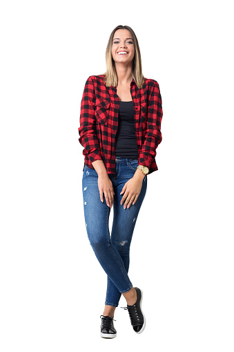 Spontaneously laughing relaxed young pretty casual woman in jeans and plaid shirt. Full body length standing portrait isolated over white background.