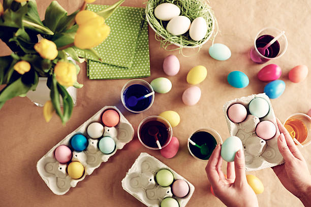 istock Human hands holding box of dyed eggs 629169118