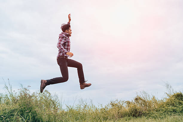 istock A man running and jumping with arms raised with energy 629169454